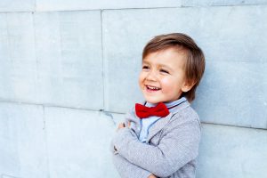 Child with bow-tie smiling
